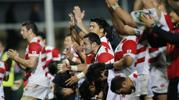 Japan players wave to the crowd after the Rugby World Cup Pool B match between USA and Japan at Kingsholm, Gloucester, England, Sunday, Oct. 11, 2015. Japan won the match 18-28. (AP Photo/Frank Augstein)