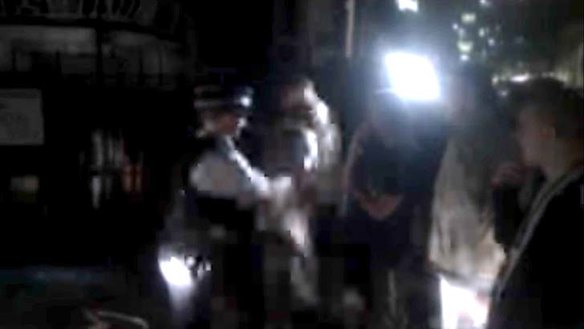 Scuffle breaks out between police and a protester outside the embassy.