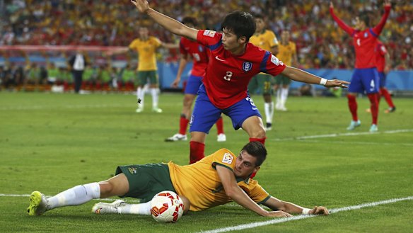 Fouled but not out: Tomi Juric of Australia competes for the ball before setting up the winning goal by James Troisi.