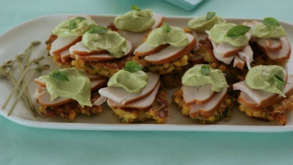 Mini corn cakes with smoked chicken and avocado mayonnaise.