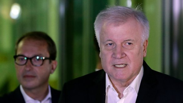 German Interior Minister and chairman of the German Christian Social Union (CDU), Horst Seehofer, right, addresses the media after the meeting.