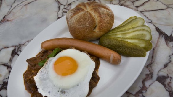 Hearty breakfast: Goulash served with a Viennese frankfurter, a fried egg and a pickled gherkin.