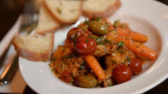 Braised rabbit with cherry tomatoes, carrots and olives.