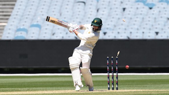 Skittled: Tasmania's Matthew Wade is bowled by Victorian paceman Peter Siddle at the MCG on Monday.