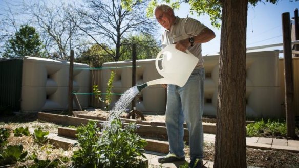Bob Gardiner watering his garden with tank water.
