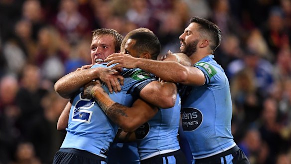 Blue streak: Tom Trbojevic (left) celebrates a runaway try for NSW.