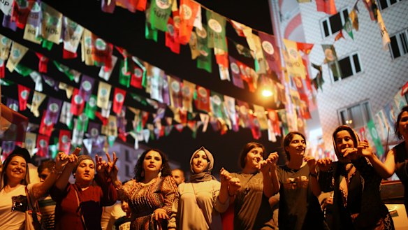 Women dance under election banners of the pro-Kurdish Peoples' Democratic Party, or HDP, in the mainly-Kurdish city of Diyarbakir.