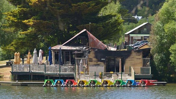 Police and fire investigators analyse the scene of the Boathouse Cafe fire.