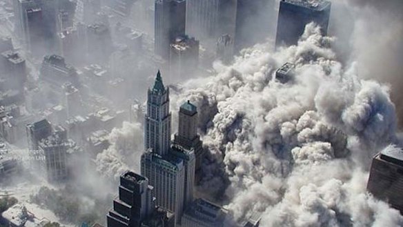 Burning buildings collapse amid huge plumes of smoke in the aftermath of the World Trace Centre attcaks.