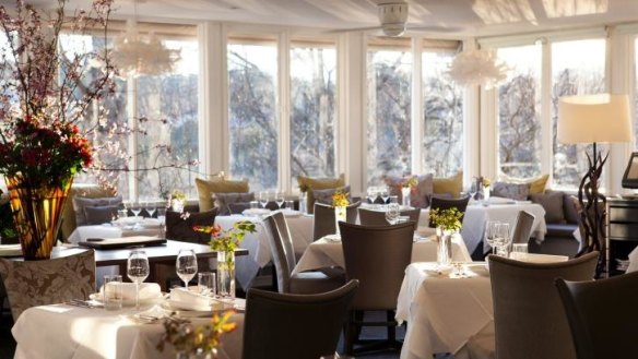 The Lake House dining room is complete with crisp white linens.