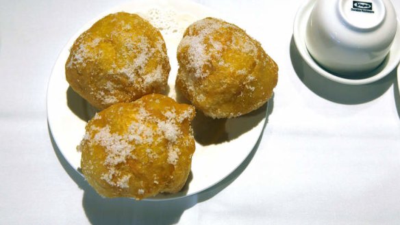 Puffy doughnuts coated in sugar.