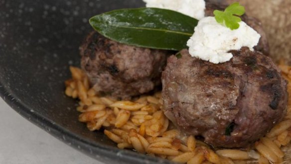 Greek meatballs with tomato-braised risoni and feta.