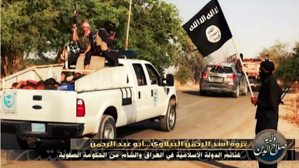 Bodies are piled into a small truck.