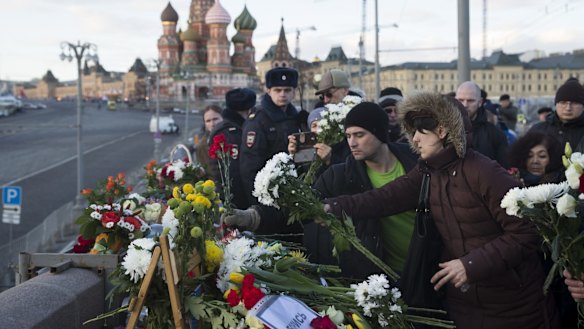 People lay flowers at the place where Boris Nemtsov was gunned down.
