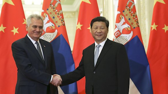 Serbian President Tomislav Nikolic, left, poses with Chinese President Xi Jinping in the Great Hall of the People in Beijing. 