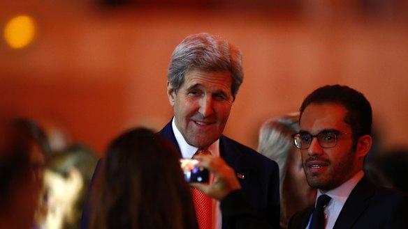 US Secretary of State John Kerry poses for a photo as he arrives at conference centre on Saturday.