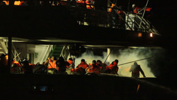 Israeli commandos are met by angry protesters wielding weapons.