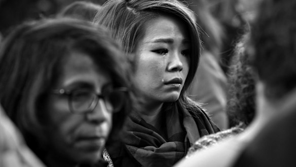 Faces of Paris. Parisians silently paid respect to the 129 people killed in the terror attack in Paris across many memorial sites including Le Carillon bar on Sunday 15 November.