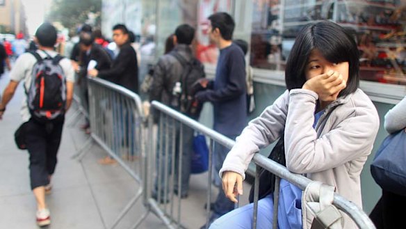Customers wait in line to purchase the iPhone 5 in New York.