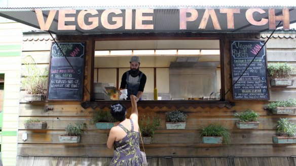 Growing business: David Toohey serves veggie burgers and sweet potato crisps from a food truck in Newtown. A report argues food trucks have opened up a new market.