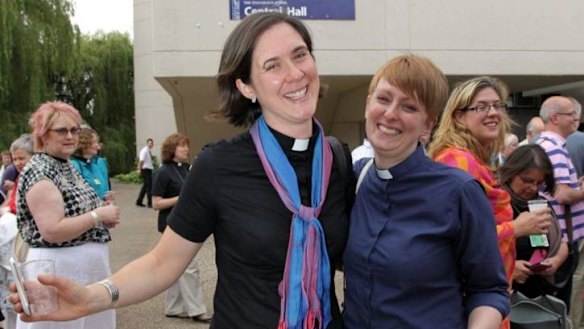 Vicars Kat Campion-Spall (left) and Claire Turner (right) celebrate outside the venue after members voted to approve the creation of female bishops at the Church of England General Synod in York.