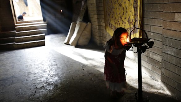 A displaced Yazidi girl worships at   Lalish temple in Shikhan last year.