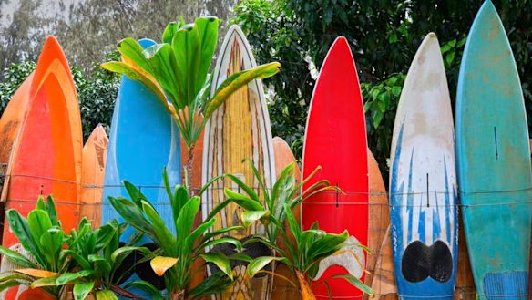 A colourfully painted surfboard fence.