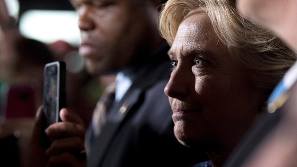 Democratic presidential candidate Hillary Clinton greets members of the audience after speaking at a rally at Theodore Roosevelt High School.