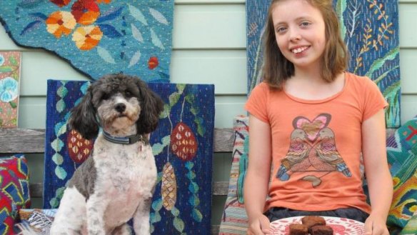 Rose Kidston, 11, with her home-made brownies and Rupert the dog.