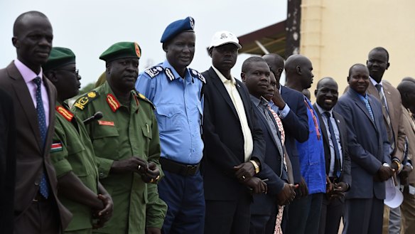 Australian citizen Yien Oral Lam, 48, from Alderley in Queensland, is seen here in his blue police uniform and beret at a ceremony to welcome rebel chief of military staff Simon Gatwech Dual back to Juba.