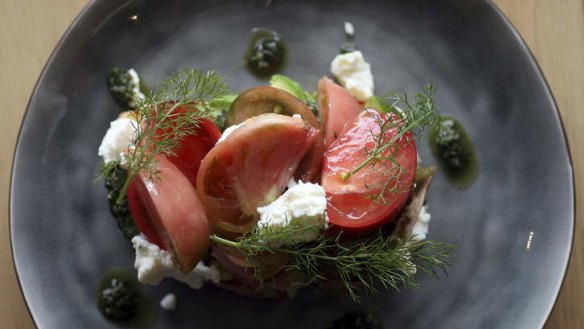 Excellent ingredients, simply assembled ... A plate of pesto, tomato and ricotta on toast.