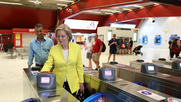 Ita Buttrose and Andrew Constance use their Opal cards at Martin Place in Sydney.