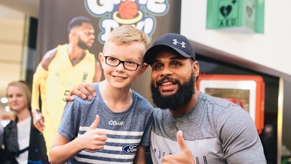Patty Mills at Belconnen for a book signing for his new book Game Day. Patty Mills congratulates Logan Harrison after Logan beat Mills in a shootout.