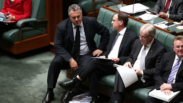 Treasurer Joe Hockey and Environment Minister Greg Hunt in discussion during QT. Photo: Alex Ellinghausen