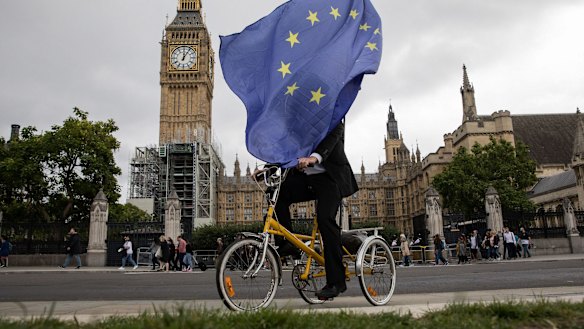 An anti-Brexit demonstrator cycles outside the Houses of Parliament in London. "We are looking at Brexit with interest but not fear," says Macquarie Group chief executive Nic Moore.