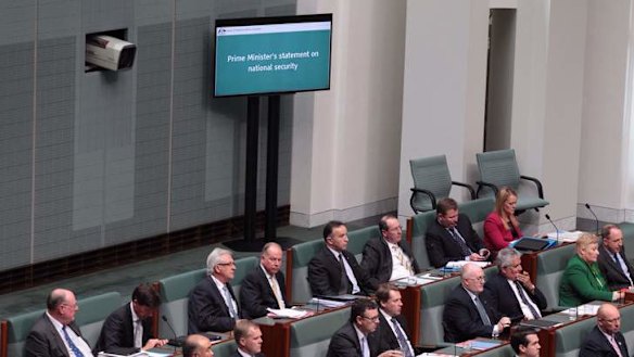 New screens on the floor of the House of Representatives display Prime Minister Tony Abbott's statement on national security on Monday. Photo: Andrew Meares