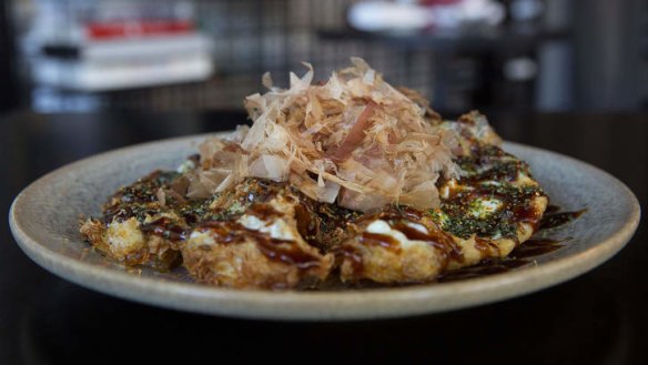 Deep-fried eggs are topped with oyster sauce and shaved bonito swirls.
