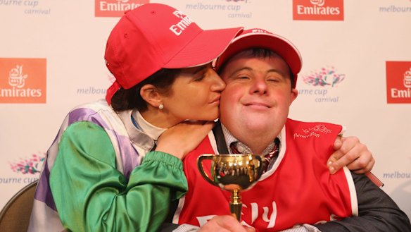 Michelle Payne celebrates her winning ride with brother and strapper Steven Payne.