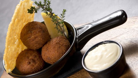 Arancini balls with a parmesan crisp and aioli on the side.