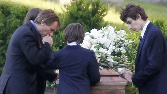Robert F. Kennedy Junior, left, kneels with his children at the casket of Mary Richardson Kennedy on May 19, 2012.