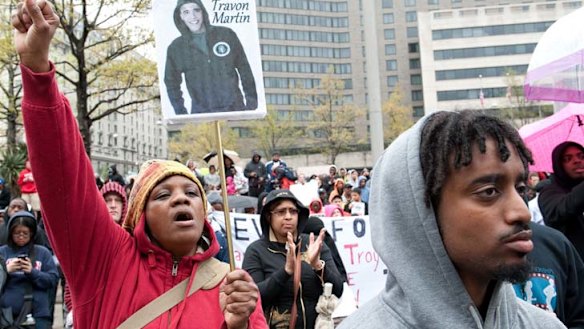 National debate ... a Hoodies on the Hill demonstration on Capitol Hill; one banner has a picture of President Obama in a hoodie and reads ''I am Trayvon Martin''.
