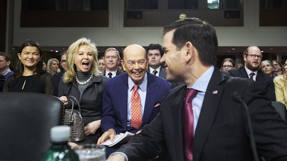 Wilbur Ross and his wife Hilary Geary smile as Senator Marco Rubio, a Republican from Florida, right, introduces Ross during Ross'  confirmation hearing in Washington.