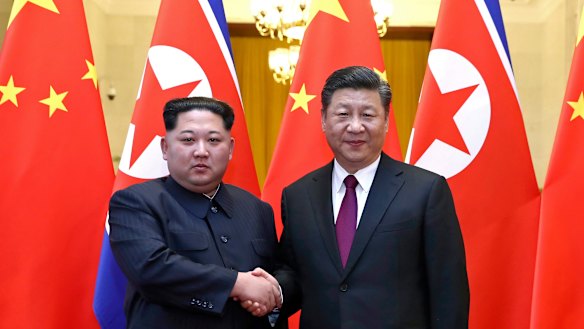North Korean leader Kim Jong-un, left, and Chinese President Xi Jinping shake hands in Beijing, China. 