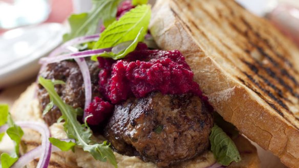 Meatball sandwich with hummus and beetroot.