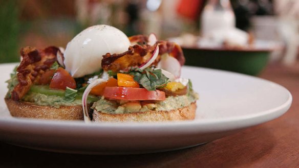 Avocado on toast with heirloom tomatoes, crisp pancetta and a poached egg.