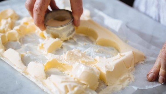 Use a cookie cutter to cut out discs of ice-cream for hot cross bun ice-cream sandwiches.