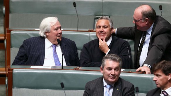 Palmer United Party leader Clive Palmer and Treasurer Joe Hockey in discussion during a division in the House of Representatives on Monday evening. Photo: Alex Ellinghausen