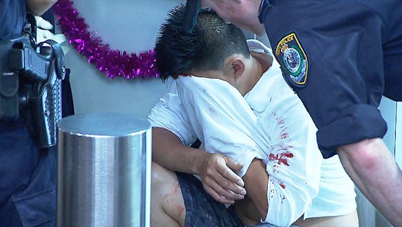 Police help a man after he was assaulted in Sydney on December 22.
