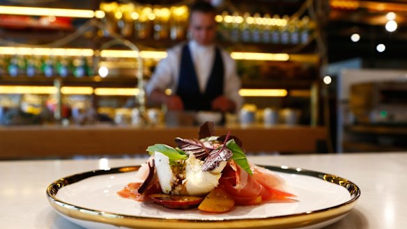 Buffalo mozzarella, peaches, purple basil, prosciutto and traditional balsamic vinegar dish at L'Americano Espresso Bar. 