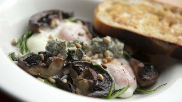 Baked eggs, spinach, and mushrooms scattered with blue cheese.
